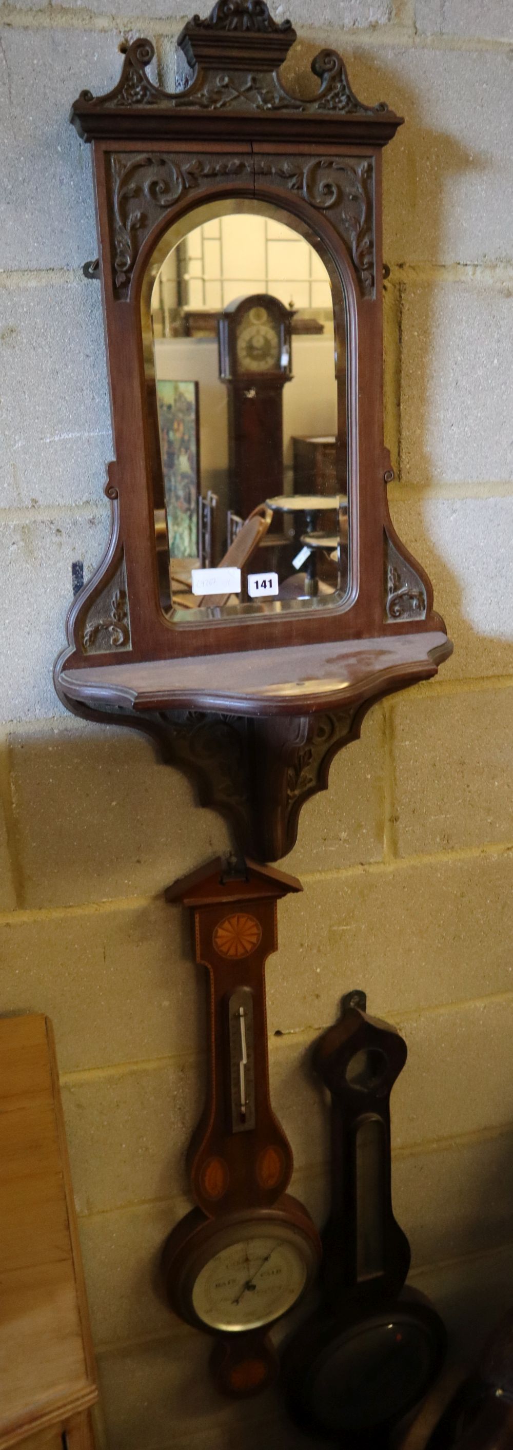 A late Victorian mirrored wall bracket and two wheel barometers